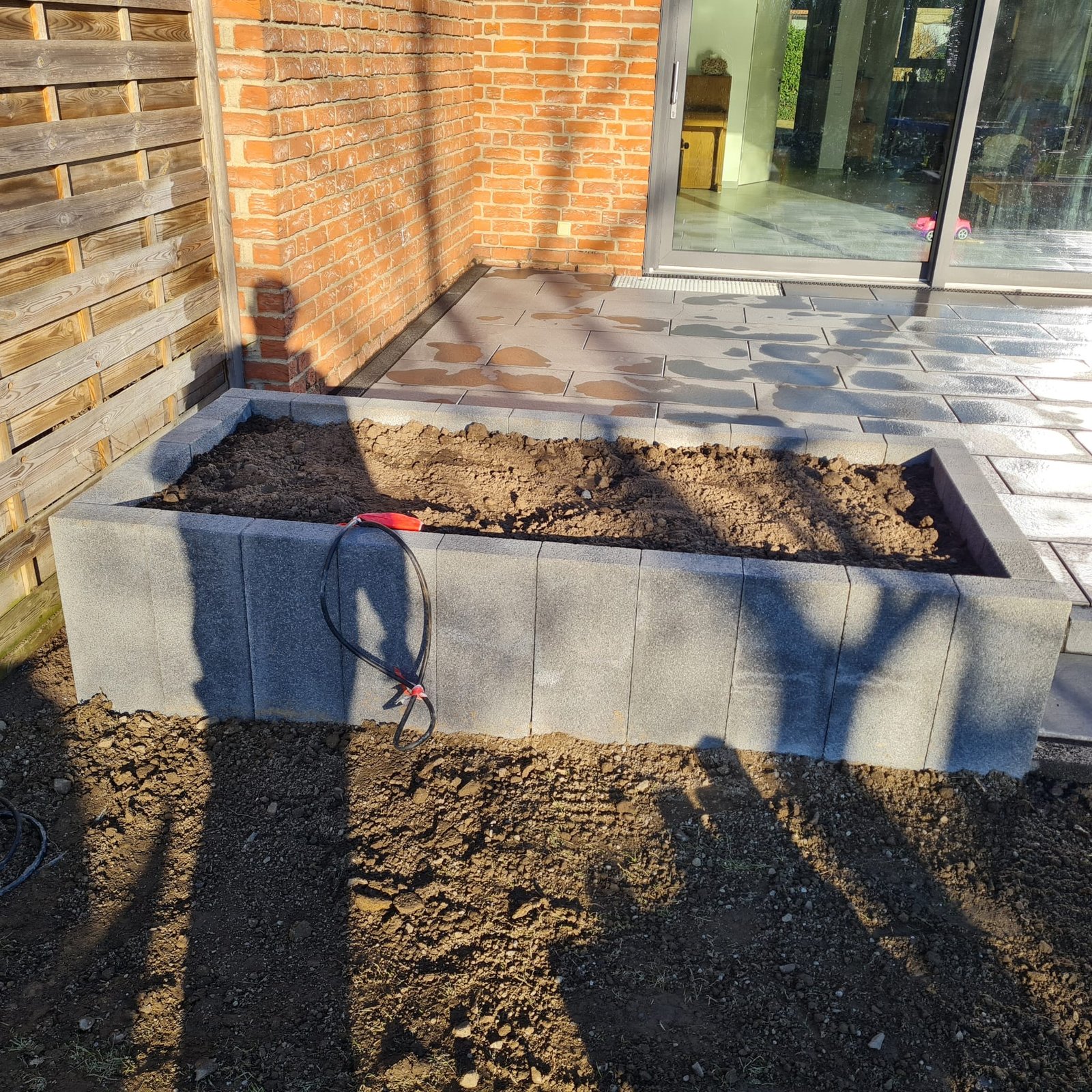Mitarbeiter von Johnson Galabau beim Verlegen großformatiger Terrassenplatten
